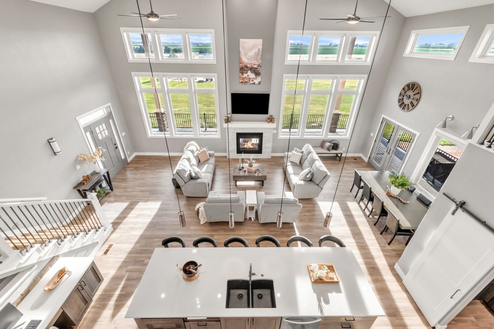 Great room with vaulted ceilings and tall windows in a Weld County home listed by Suzy